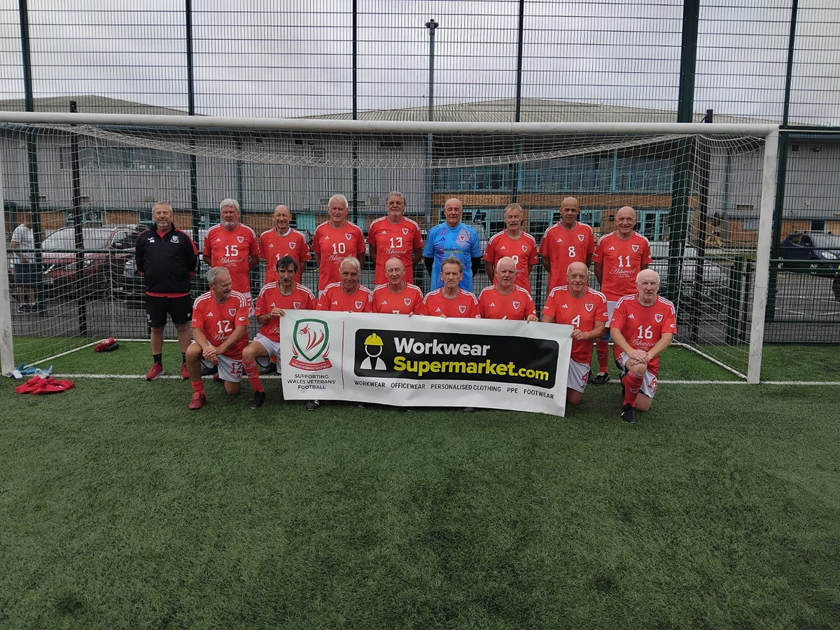 Wales Veterans football squad proudly pictured with their Workwear Supermarket sponsorship banner